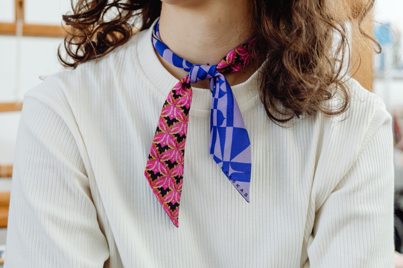 Close view of a patterned scarf worn over clothing.